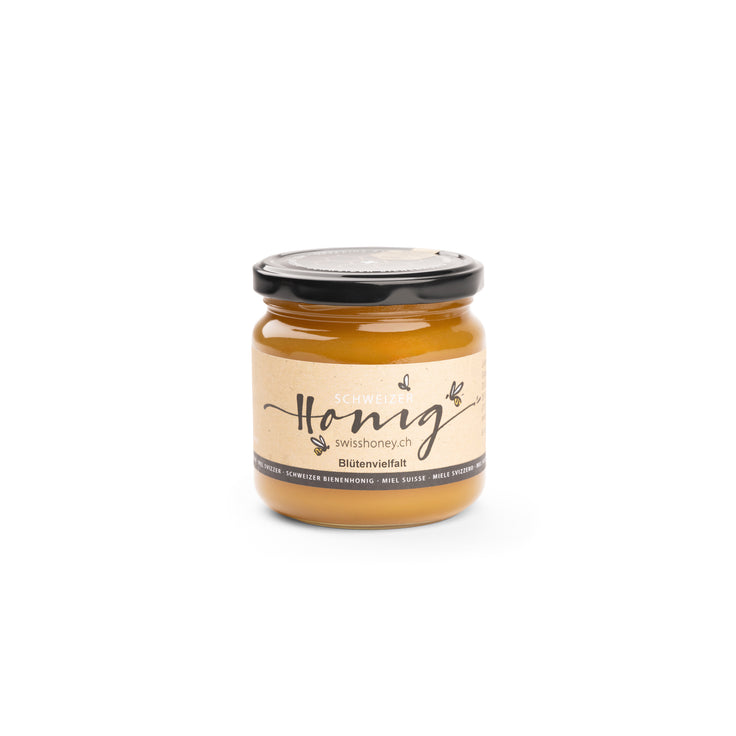 Swiss blossom honey in a glass jar with a black lid
